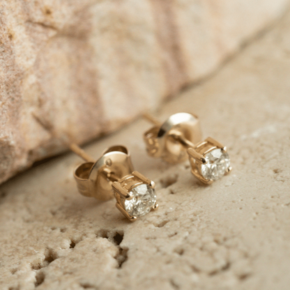 A pair of classic, brilliant cut Diamond Stud Earring set in gold.