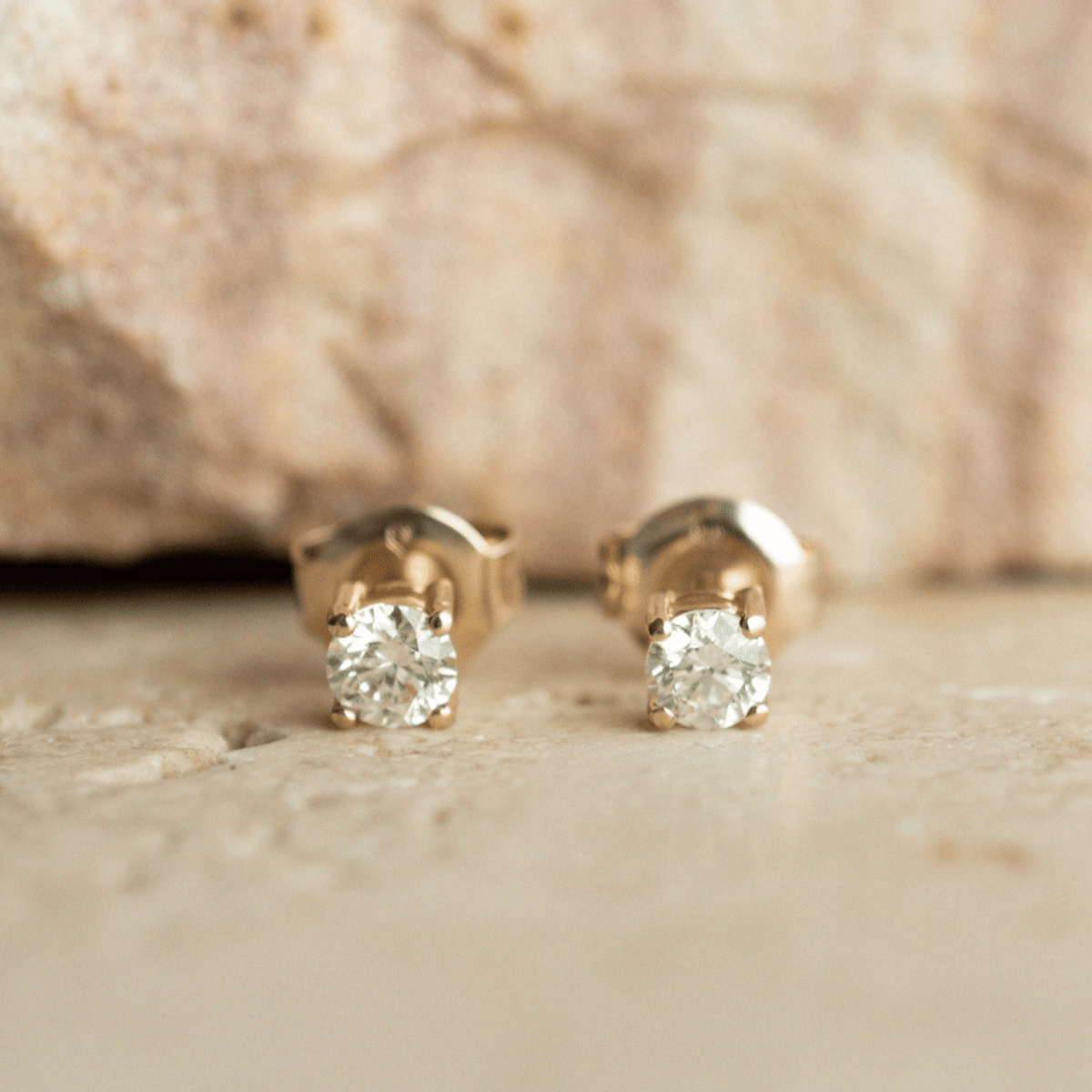 A pair of classic, brilliant cut Diamond Stud Earring set in gold.