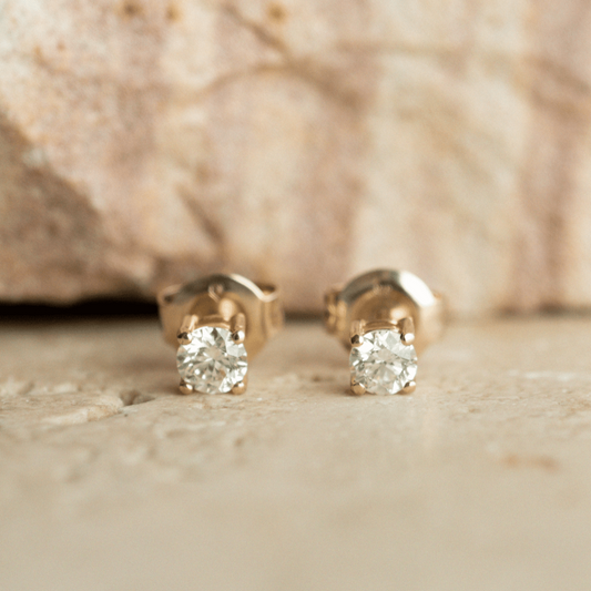 A pair of classic, brilliant cut Diamond Stud Earring set in gold.