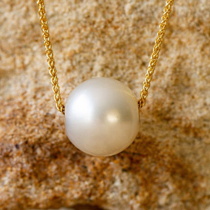 A beautiful, round pearl from our Cygnet Bay Pearl Farm set on a gold chain.