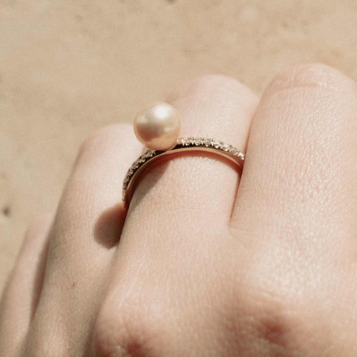 A stunning Eternal Diamond Pearl Ring featuring our Broken Bay grown Australian Akoya pearl set alongside a row of white glimmering diamonds on a gold band. 