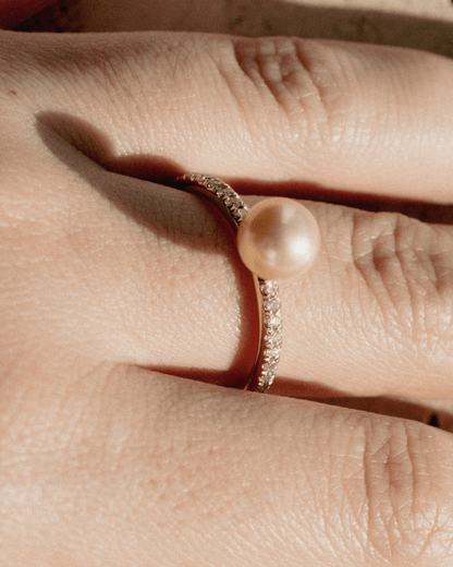 A stunning Eternal Diamond Pearl Ring featuring our Broken Bay grown Australian Akoya pearl set alongside a row of white glimmering diamonds on a gold band. 