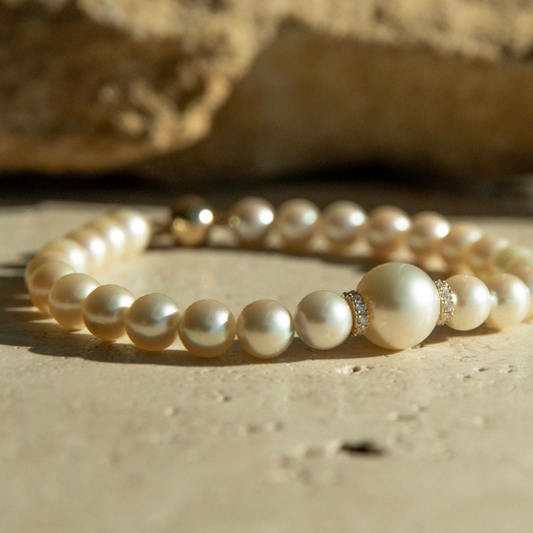 This Eternal South Sea &amp; Akoya Pearl Strand Bracelet features twenty-four (24) Broken Bay (NSW) grown 7.5mm AAA grade Australian Akoya pearls with one (1) Cygnet Bay (WA) grown 10mm Round B1 grade Australia South Sea pearl set alongside two White Diamond rondels (0.22ct H/SI). This 18.5cm pearl strand is carefully hand strung with silk and set with an 18ct Yellow Gold Ball Clasp.
