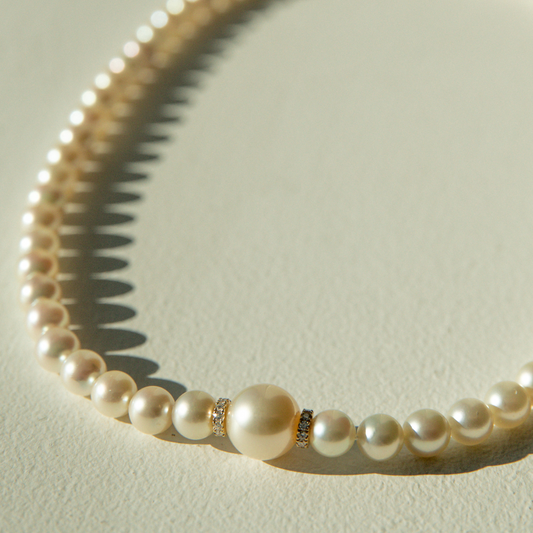 This Eternal South Sea &amp; Akoya Pearl Strand Necklace features fifty-eight (58) Broken Bay (NSW) grown 7.5mm AAA grade Australian Akoya pearls with one (1) Cygnet Bay (WA) grown 10mm Round A1 grade Australia South Sea pearl set alongside two White Diamond rondels (0.22ct H/SI). This 43cm pearl strand is carefully hand strung with silk and set with an 18ct Yellow Gold Ball Clasp.