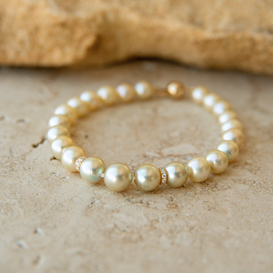 Pearl strand bracelet on a textured beige surface