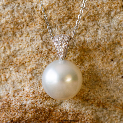 A beautiful Australian South Sea pearl pendant set with a stunning array of white diamonds in gold. 