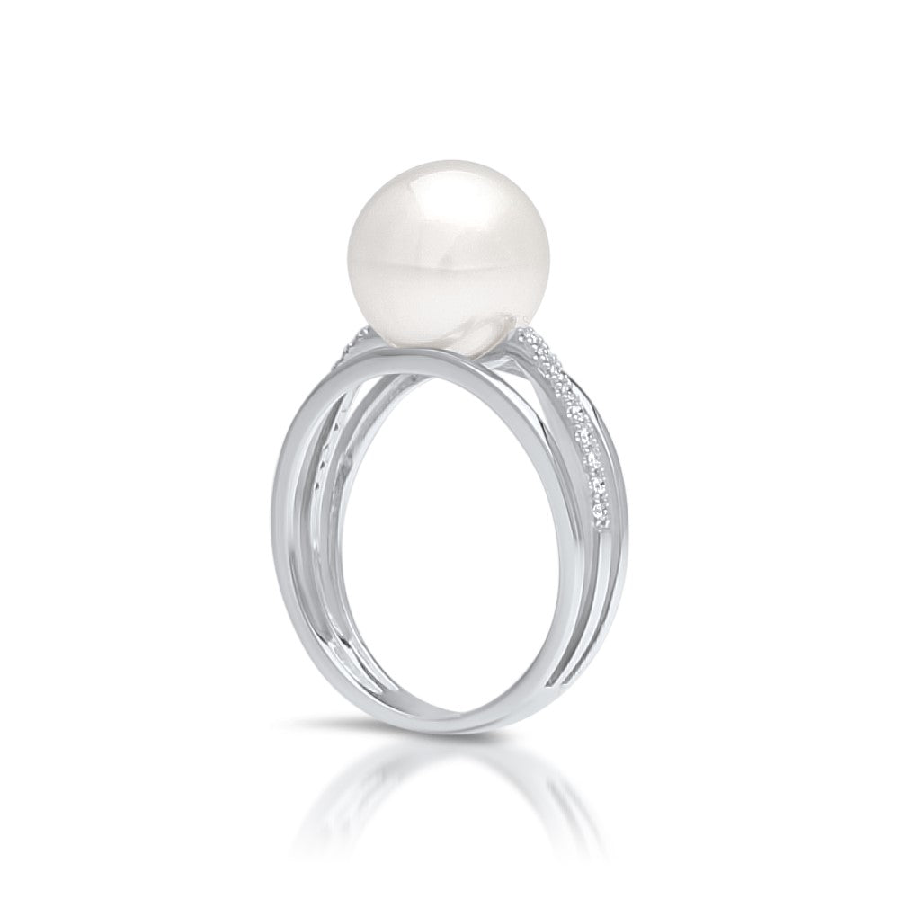 An Eternal Pearl Ring featuring an Australian South Sea pearl set alongside a band of white diamonds in white gold. 