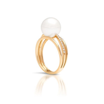 An Eternal Pearl Ring featuring an Australian South Sea pearl set alongside a band of white diamonds in yellow gold. 