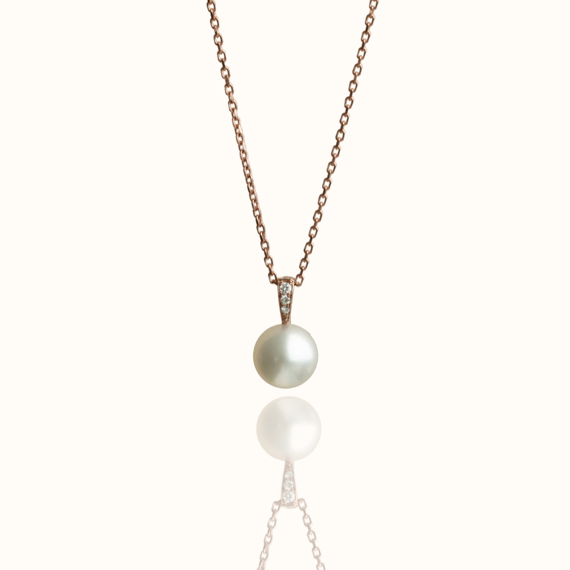 A stunning Australian South Sea pearl set on a rose gold pendant, with three white diamonds on the bail of the design.