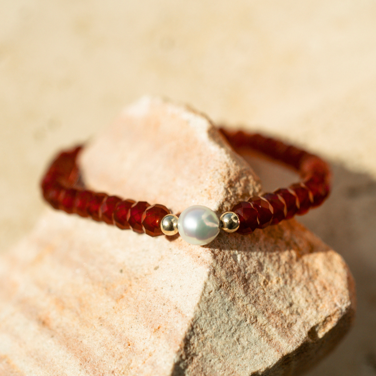 This bracelet features a Broken Bay (NSW) grown 7mm AAA grade Australian Akoya pearl complemented by 41 faceted Carnelian beads and two 9ct yellow gold rondels.