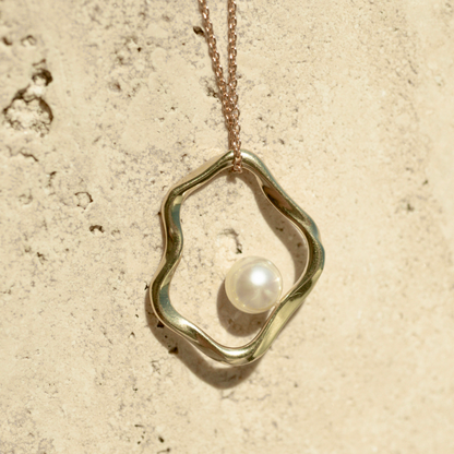 A graceful Flow Pearl Pendant featuring a Broken Bay (NSW) grown 7mm AA grade Australian Akoya Pearl set in an organic gold plated sterling silver design.

