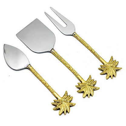 Set of four silver and gold leaf-themed utensils on a white background