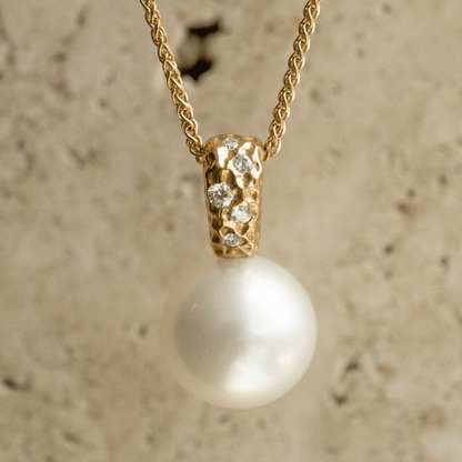 A stunning Australian South Sea pearl set on an Impressions pendant design featuring several white diamonds. 