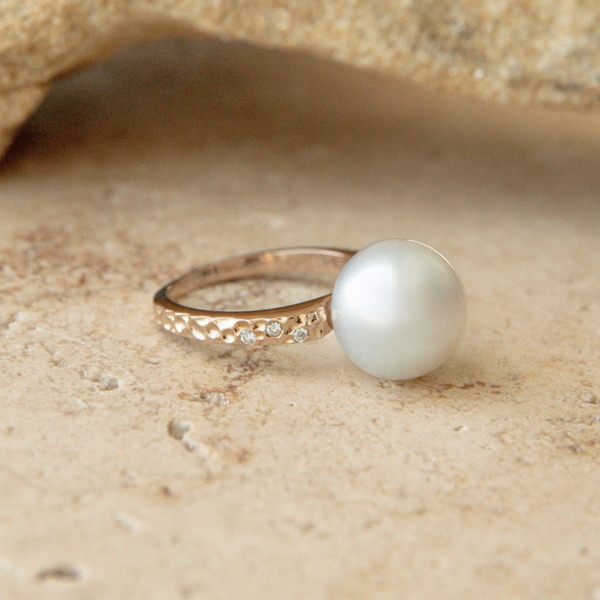 Pearl ring on a sandy surface