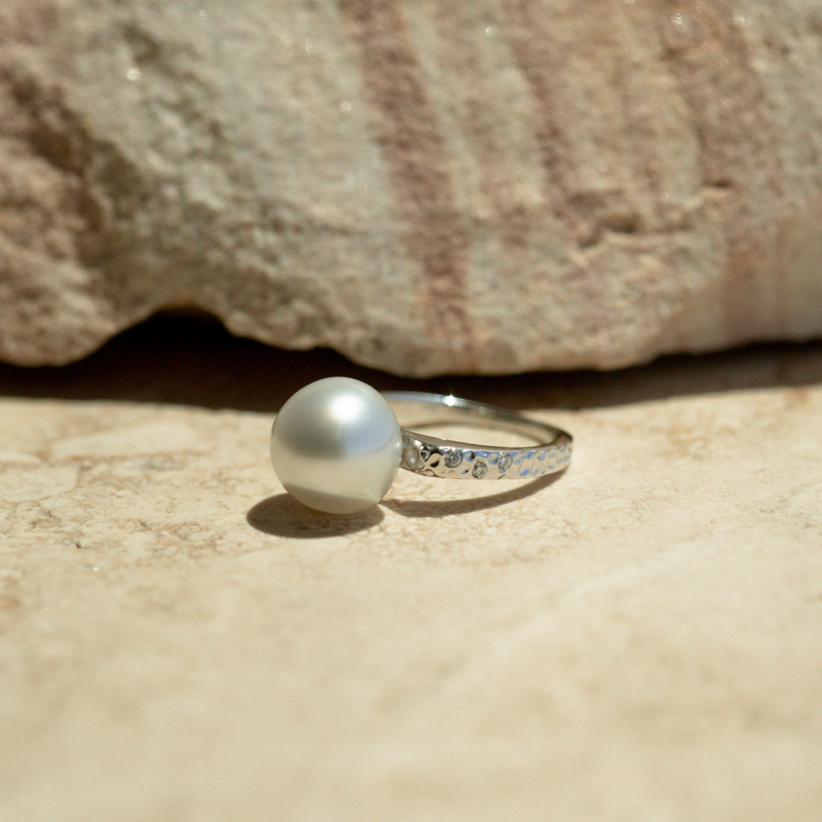 This beautiful 18ct white gold hammered ring from the Impressions collection features a beautiful 10.5mm High Button A1 grade Cygnet Bay (WA) grown South Sea Pearl complimented by 6 White Diamonds (0.06 H/SI) in a size #M.