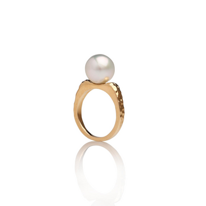 A stunning Australian South Sea pearl set on a hammered yellow gold ring design.