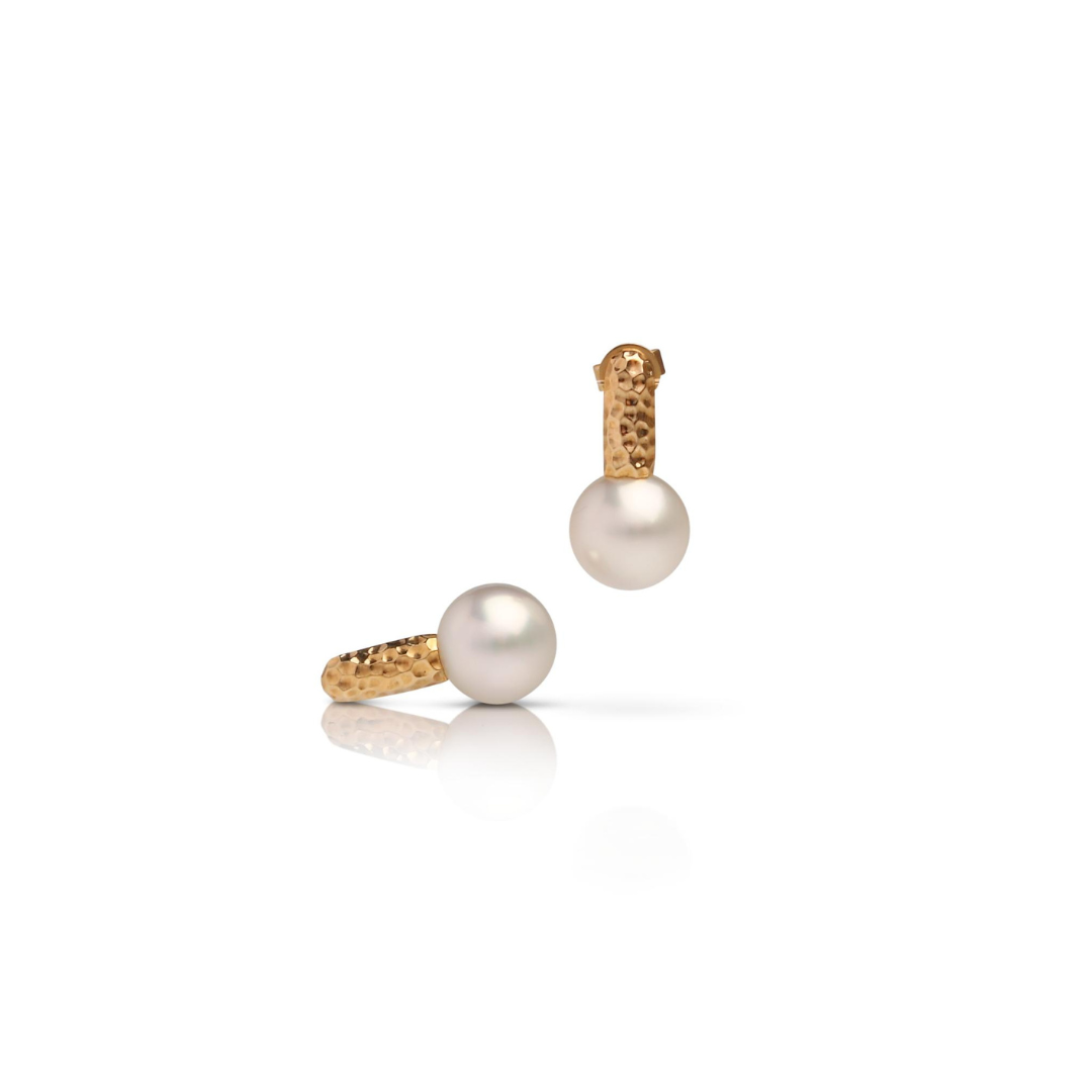 A pair of stunning Australian South Sea pearls set in a hammered yellow gold design.