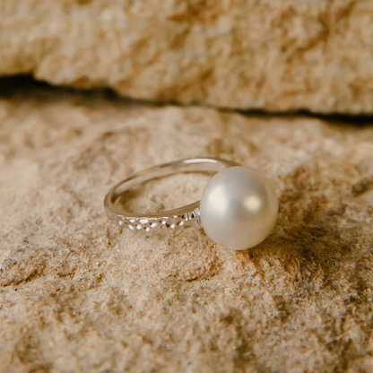 A stunning Australian South Sea pearl set on a hammered yellow gold ring design.