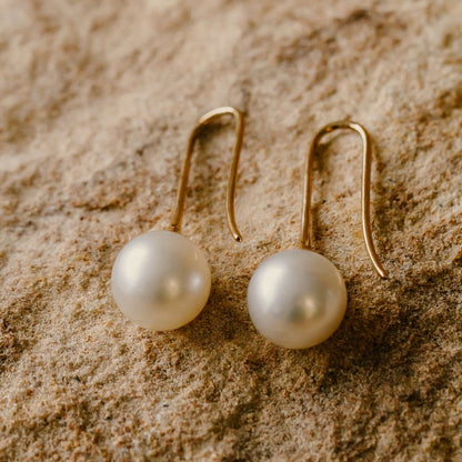 A pair of stunning Australian South Sea pearl hooks set on a solid gold design.