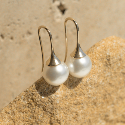 A pair of stunning Australian South Sea pearl hooks set on a solid gold design.