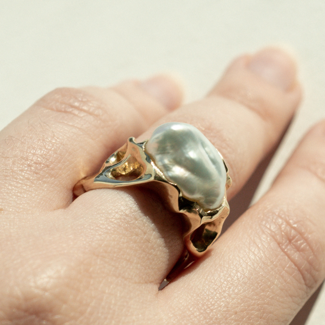 A person wears their Keepsake Pearl Ring featuring a Cygnet Bay (WA) grown Australian South Sea Keshi pearl set in a bespoke gold design.