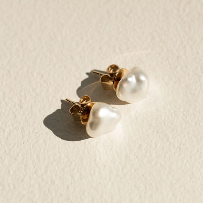 A pair of Australian South Sea Keshi pearl studs set in solid gold.