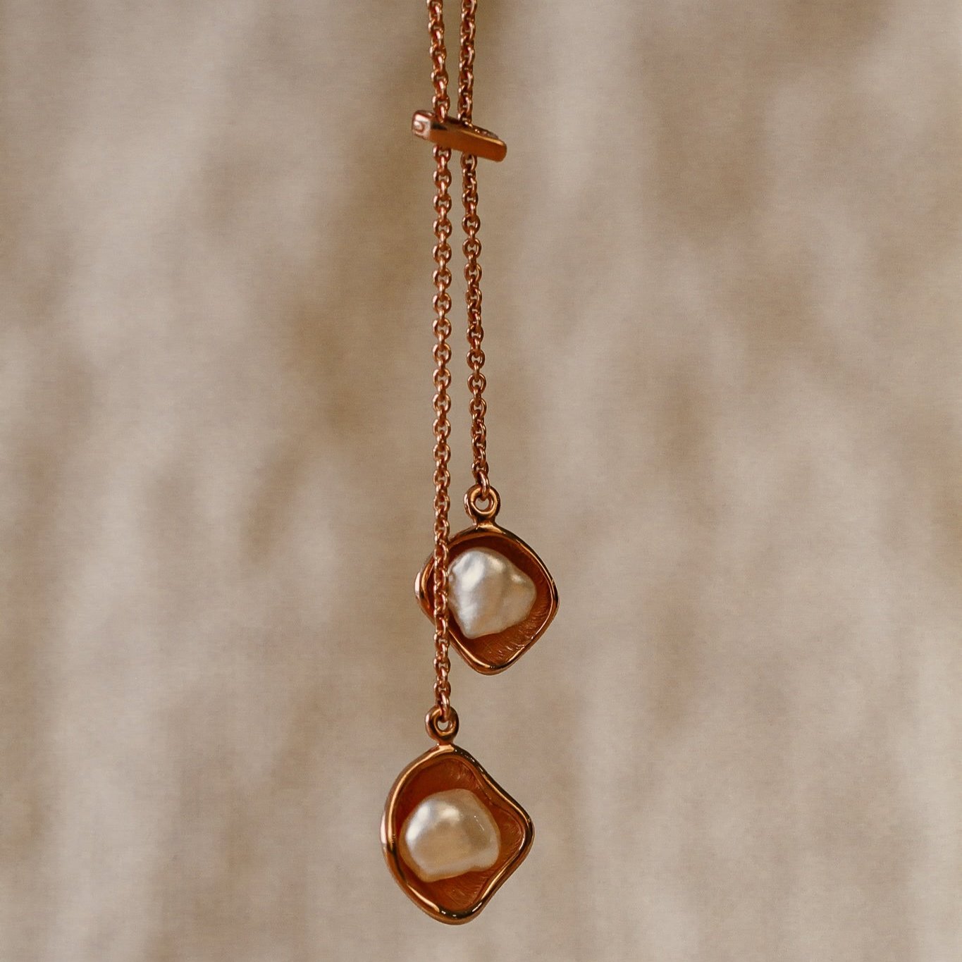 A beautiful Kimberley Lily Lariat featuring two Australian South Sea Keshi pearls set in a unique lily inspired design, on a delicate gold chain.