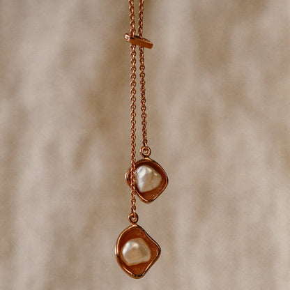 A beautiful Kimberley Lily Lariat featuring two Australian South Sea Keshi pearls set in a unique lily inspired design, on a delicate gold chain.