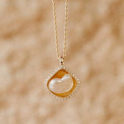 A stunning Kimberley Lily Diamond Pendant featuring an Australian South Sea Keshi pearl set in gold with a diamond halo.