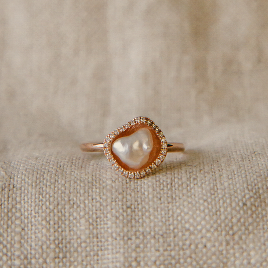 A stunning Kimberley Lily Petite Diamond Pearl Ring featuring an Australian South Sea Keshi pearl set in gold with a halo of sparkling white diamonds.