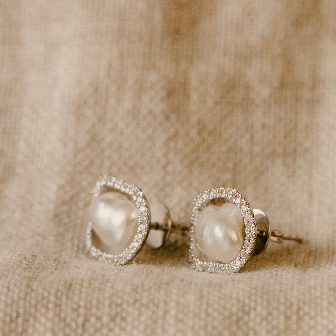 A pair of beautiful Kimberley Lily Diamond Studs featuring a pair of Cygnet Bay grown Australian South Sea Keshi pearls set in a unique lily inspired design, with a halo of sparkling white diamonds.