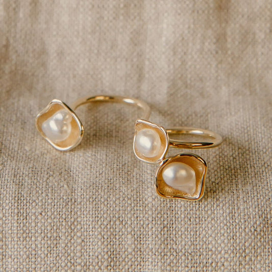 A stunning float ring that features three keshi pearls set in a stunning lily design.