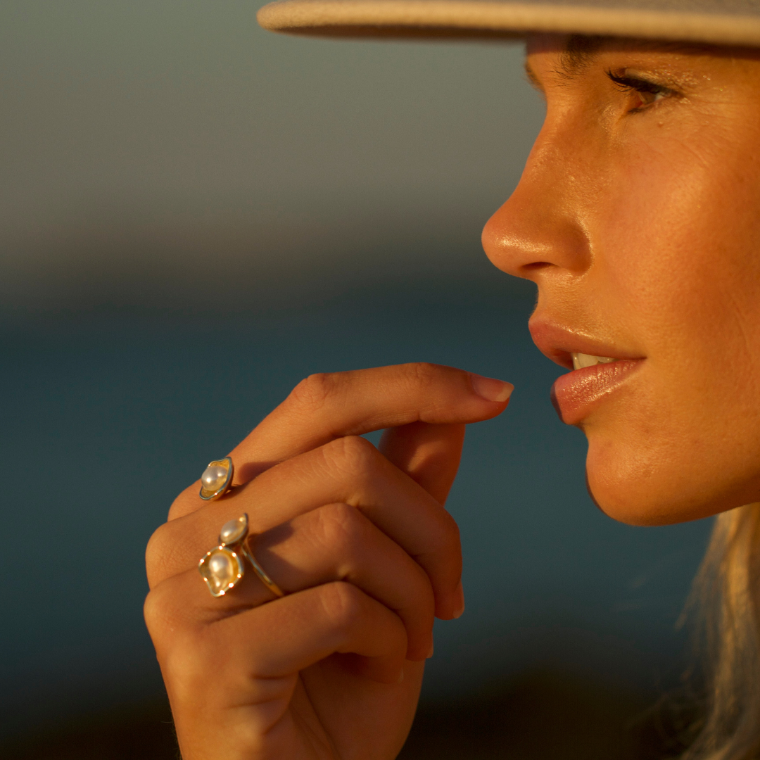 A woman wears her stunning Kimberley Lily Float Ring featuring a Cygnet Bay (WA) grown Australian South Sea Keshi pearl set in a unique gold design.