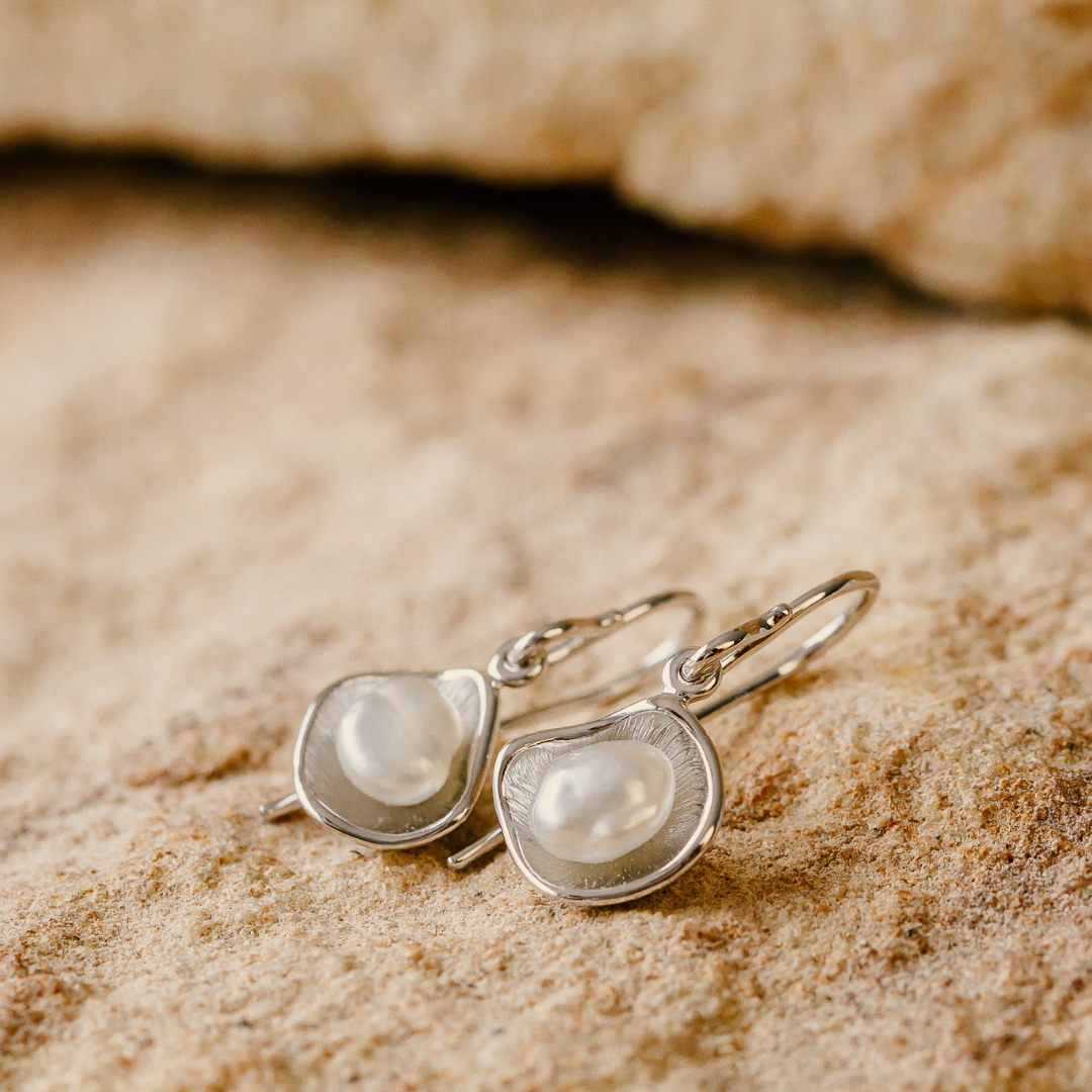 Kimberley Lily pearl hook earrings that feature a pair of beautiful Australian grown South Sea Keshi pearls set in a unique lily inspired design, in white gold.