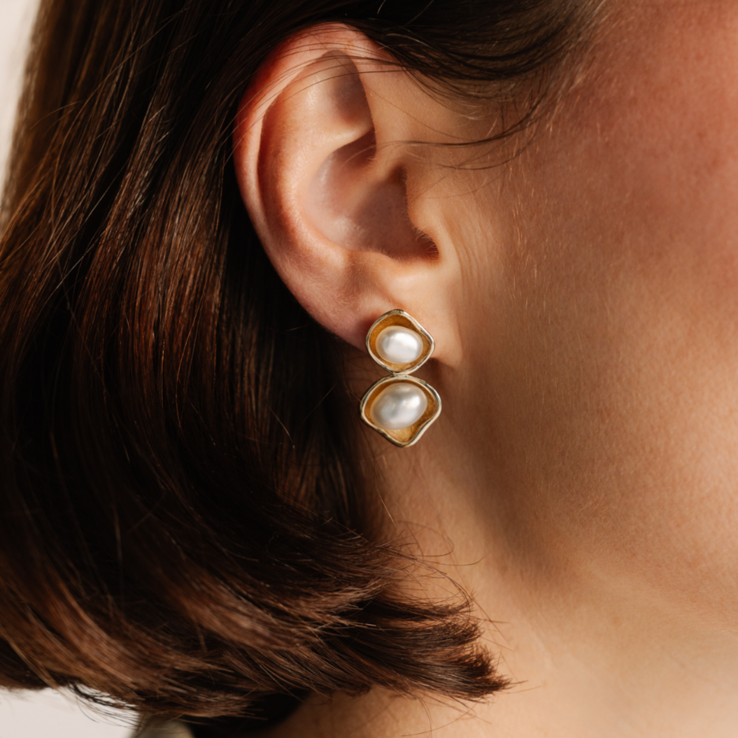 These stunning Kimberley Lily Twin Pearl Studs features our Cygnet Bay (WA) grown 5-8mm A grade Australian South Sea Keshi Pearls set in a unique gold design.