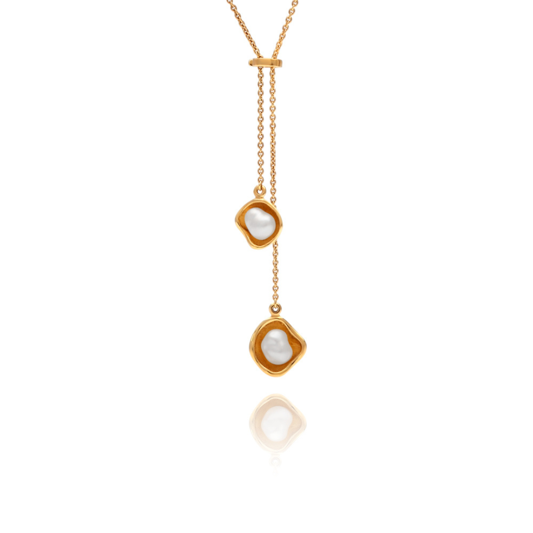 A beautiful Kimberley Lily Lariat featuring two Australian South Sea Keshi pearls set in a unique lily inspired design, on a delicate yellow gold chain.