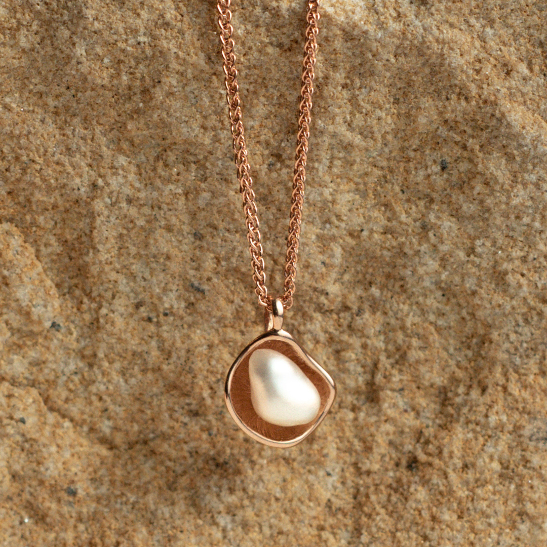 A unique Kimberley Lily Petite Pendant featuring an Australian South Sea Keshi pearl set in a unique lily inspired design.