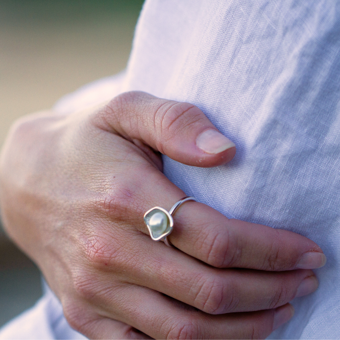 A woman wears her beautiful Kimberley Lily Ring featuring a Cygnet Bay grown Australian South Sea Keshi pearl set in a unique lily inspired design.