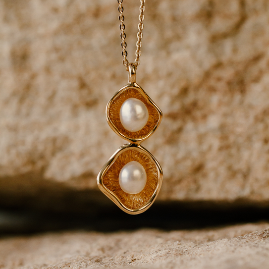 A stunning Kimberley Lily twin pendant featuring a pair of Cygnet Bay grown Australian South Sea keshi pearls set in a unique lily inspired design, in gold. 