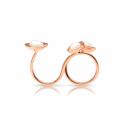 A stunning float ring that features three keshi pearls set in a stunning lily design in rose gold.