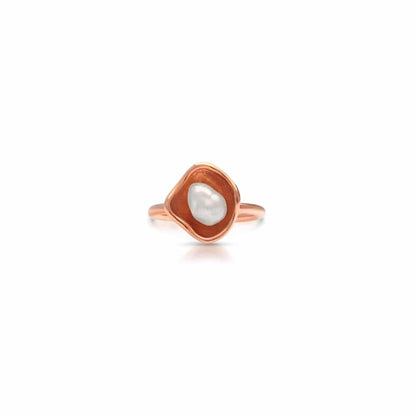 Rose gold ring with a pearl on a white background