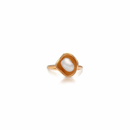 Gold ring with a central pearl on a white background