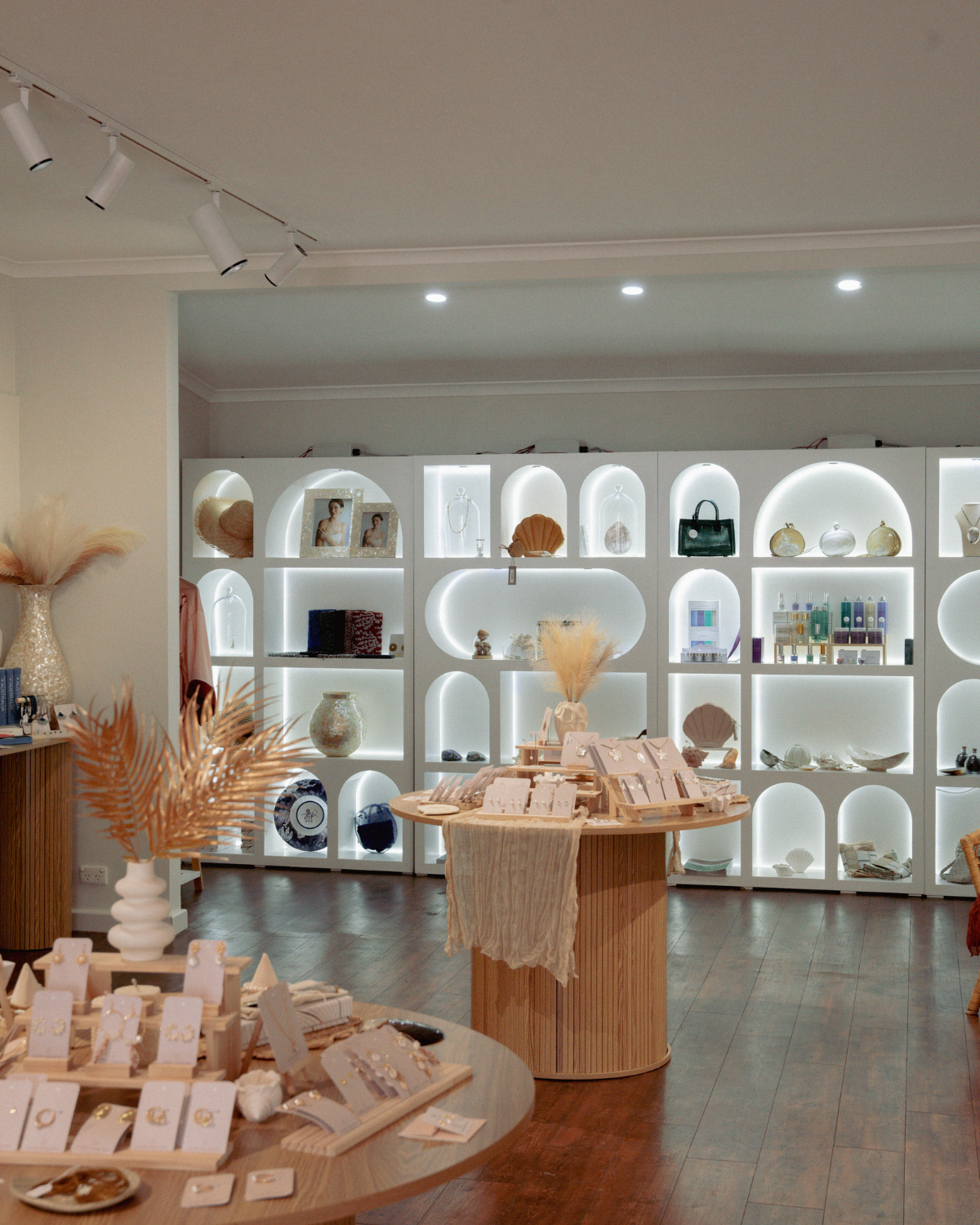 Display area with shelves and decorative items in a store or showroom setting at our Lustre Collective flagship store.