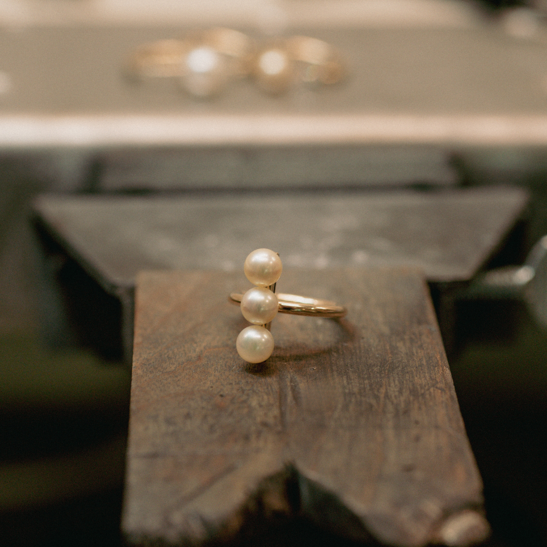 A triple Akoya pearl ring sits on our jeweller's workshop bench, after being hand crafted at our Perth Studio.