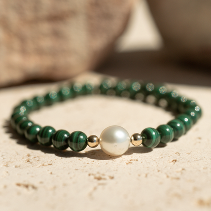 Featuring a luminous Cygnet Bay (WA) grown 8.5mm Near Round B1 grade Australian South Sea pearl nestled alongside 28 malachite beads and two 9ct yellow gold rondels