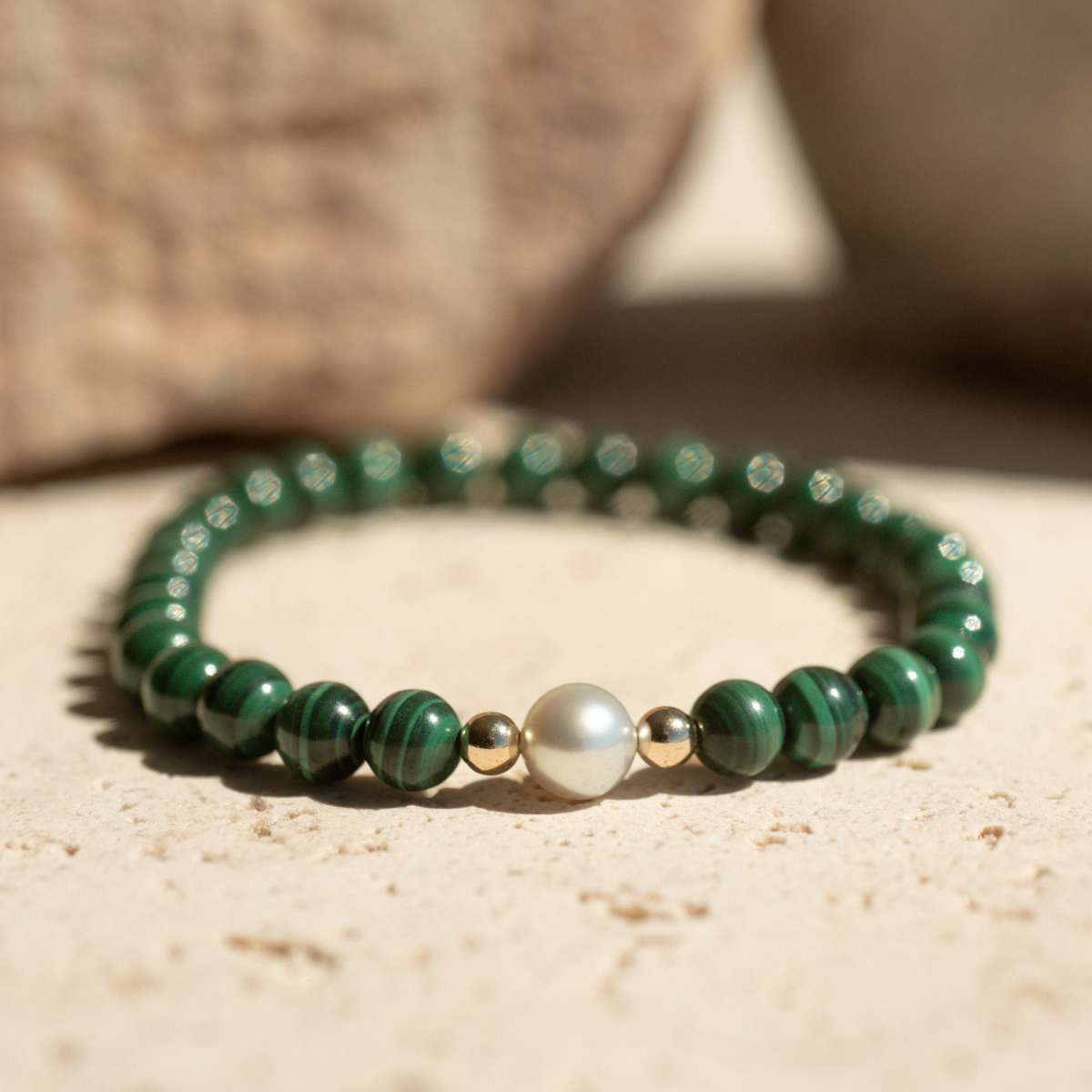 Featuring a luminous Broken Bay (WA) grown 7mm AAA grade Australian Akoya pearl nestled alongside 28 malachite beads and two 9ct yellow gold rondels