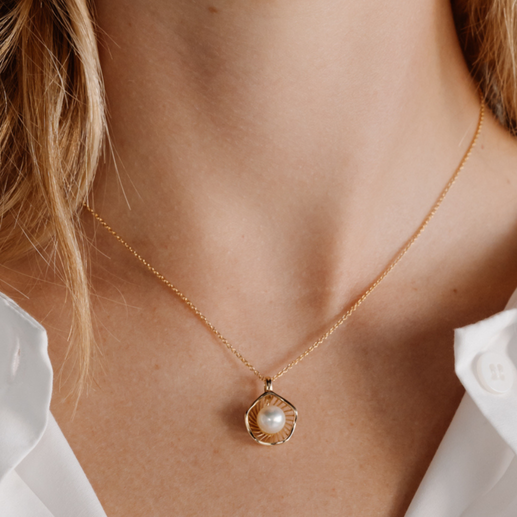 A stunning Mangrove Lily Pearl Pendant featuring a Broken Bay (NSW) 7mm AAA grade Australian Akoya pearl set in 9ct gold. Mirroring the Mangrove Lily, the filigree metalwork featured in the design of this collection evokes the umbrella of petals belonging to this coastal marvel.