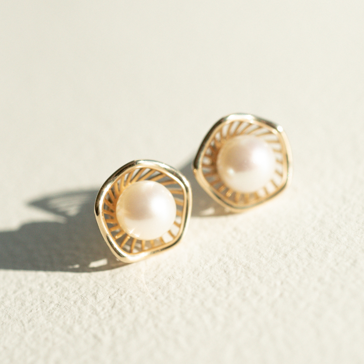 A stunning pair of Mangrove Lily Pearl Studs featuring Broken Bay (NSW) 7mm AAA grade Australian Akoya pearls set in 9ct gold. Mirroring the Mangrove Lily, the filigree metalwork featured in the design of this collection evokes the umbrella of petals belonging to this coastal marvel.