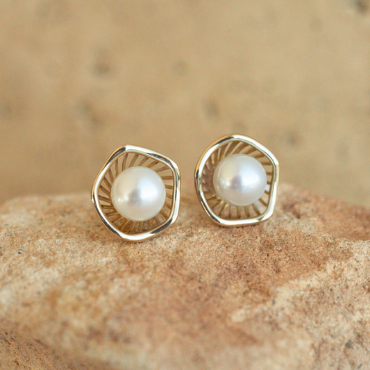 A stunning pair of Mangrove Lily Pearl Studs featuring Broken Bay (NSW) 7mm AAA grade Australian Akoya pearls set in 9ct gold. Mirroring the Mangrove Lily, the filigree metalwork featured in the design of this collection evokes the umbrella of petals belonging to this coastal marvel.