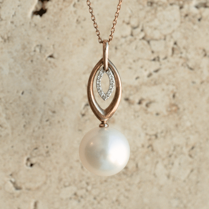 A unique Marquise Pearl Pendant featuring a round Australian South Sea pearl set alongside a marquise shaped diamond halo and gold design.